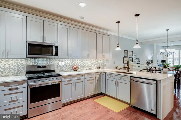 a kitchen with a sink stove and microwave