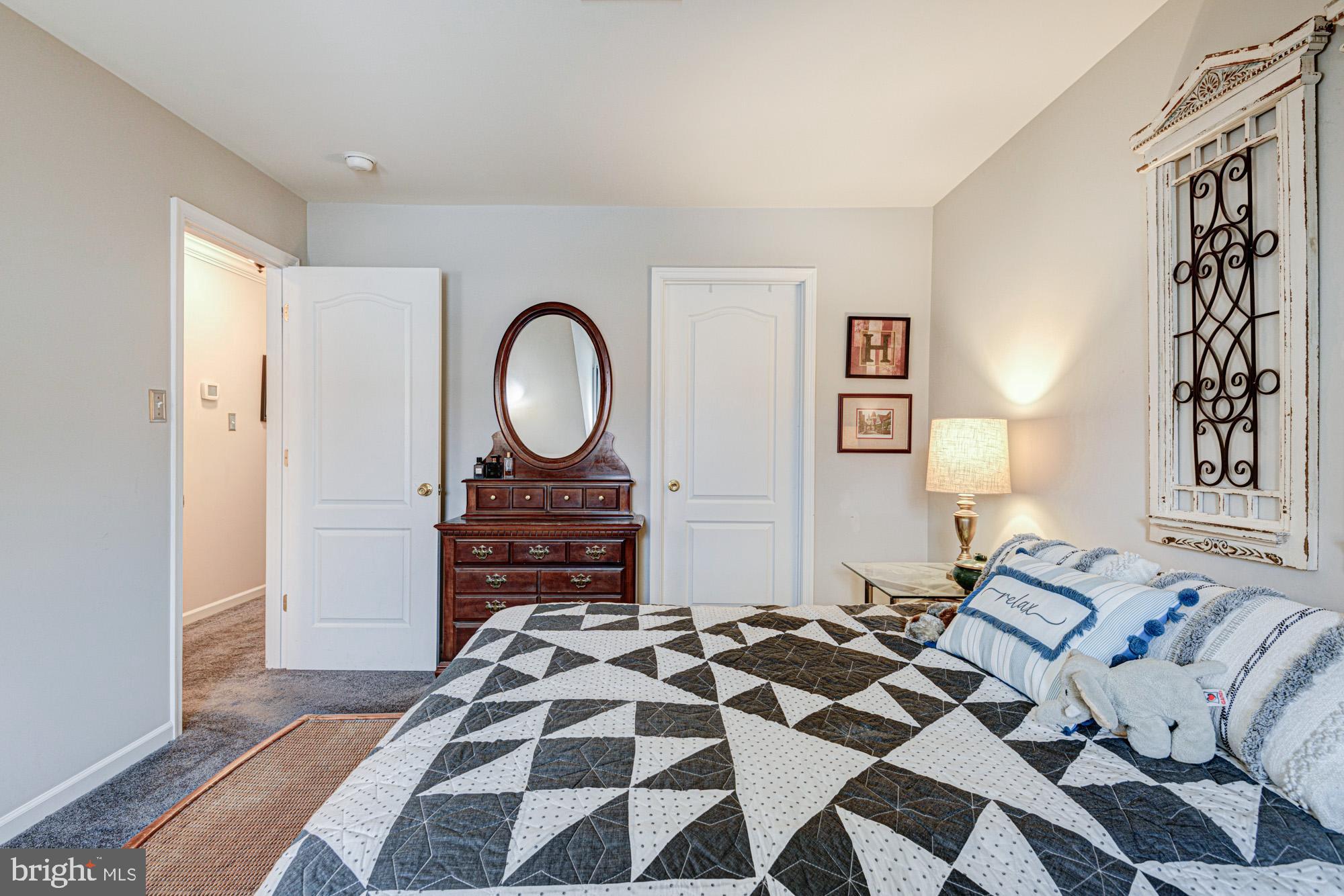 103 Candor Lane Dover, DE 19901 - Photo 23 of 38 a bedroom with a bed and a chandelier