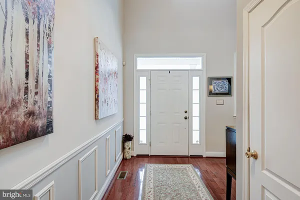 a view of hallway with wooden floor