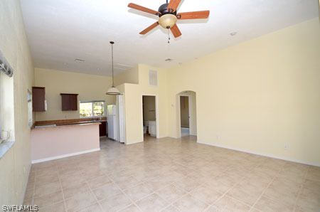 28 Michigan Road Lehigh Acres, FL 33936 - Photo 17 of 20 a view of a kitchen with a sink and a refrigerator