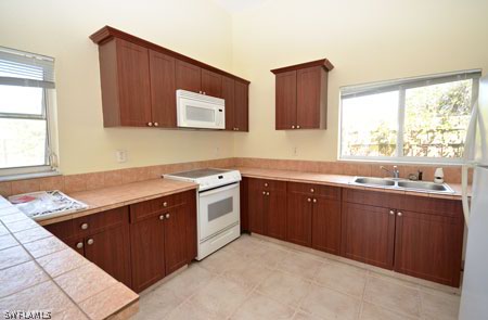 28 Michigan Road Lehigh Acres, FL 33936 - Photo 20 of 20 a kitchen with stainless steel appliances granite countertop a sink dishwasher stove and cabinets