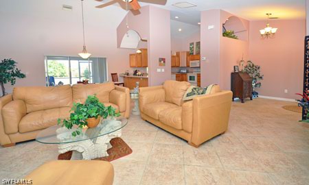28 Michigan Road Lehigh Acres, FL 33936 - Photo 6 of 20 a living room with furniture and a chandelier