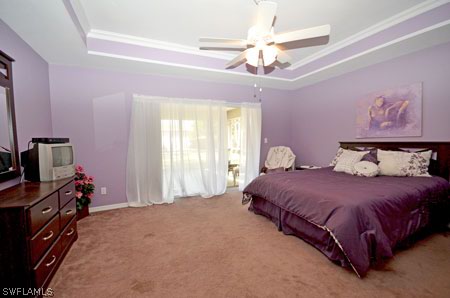 28 Michigan Road Lehigh Acres, FL 33936 - Photo 9 of 20 a bedroom with a bed dresser and a chandelier