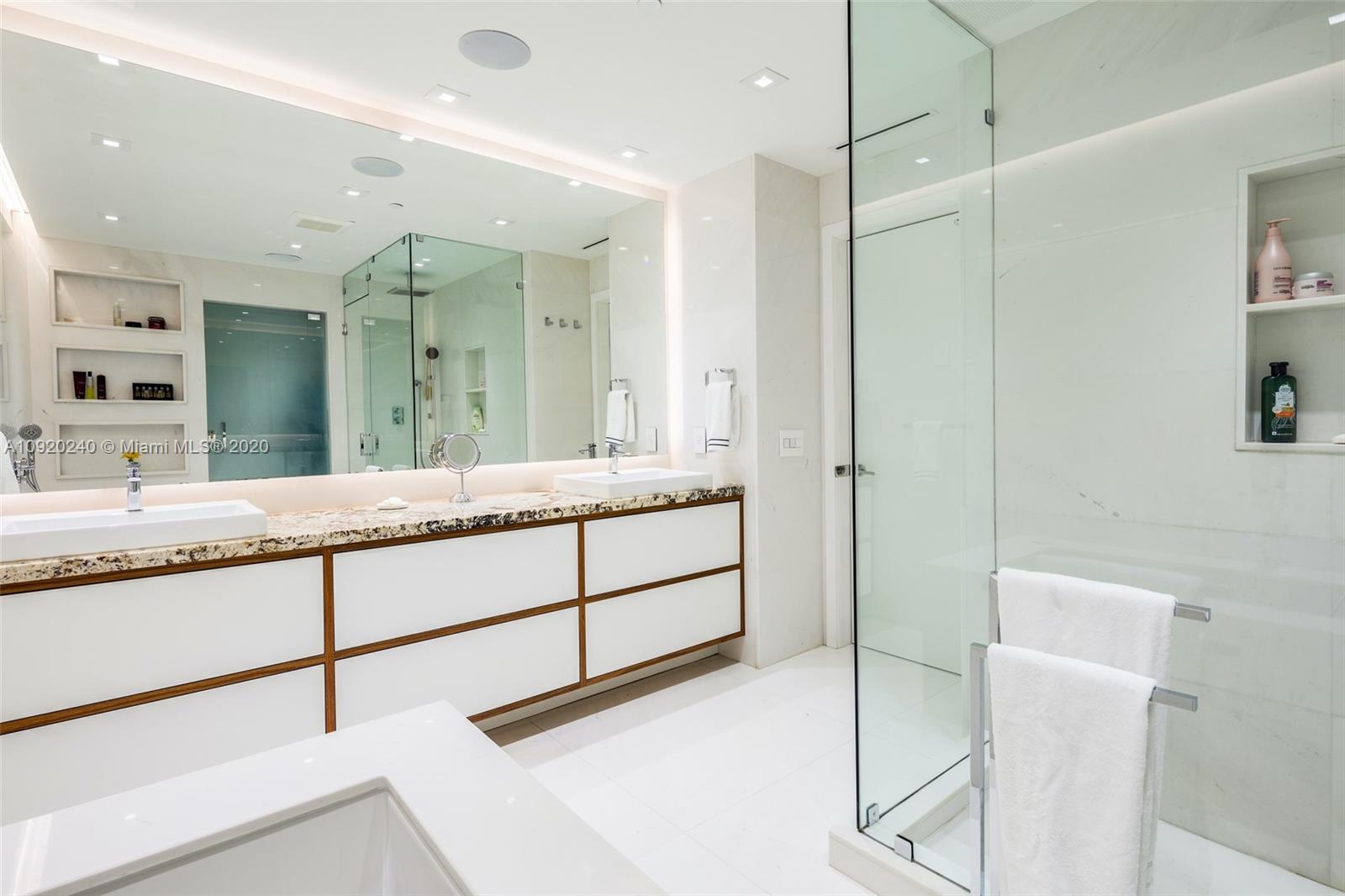 360 Ocean Drive, Unit 804S Key Biscayne, FL 33149 - Photo 16 of 49 a bathroom with a granite countertop sink mirror and double