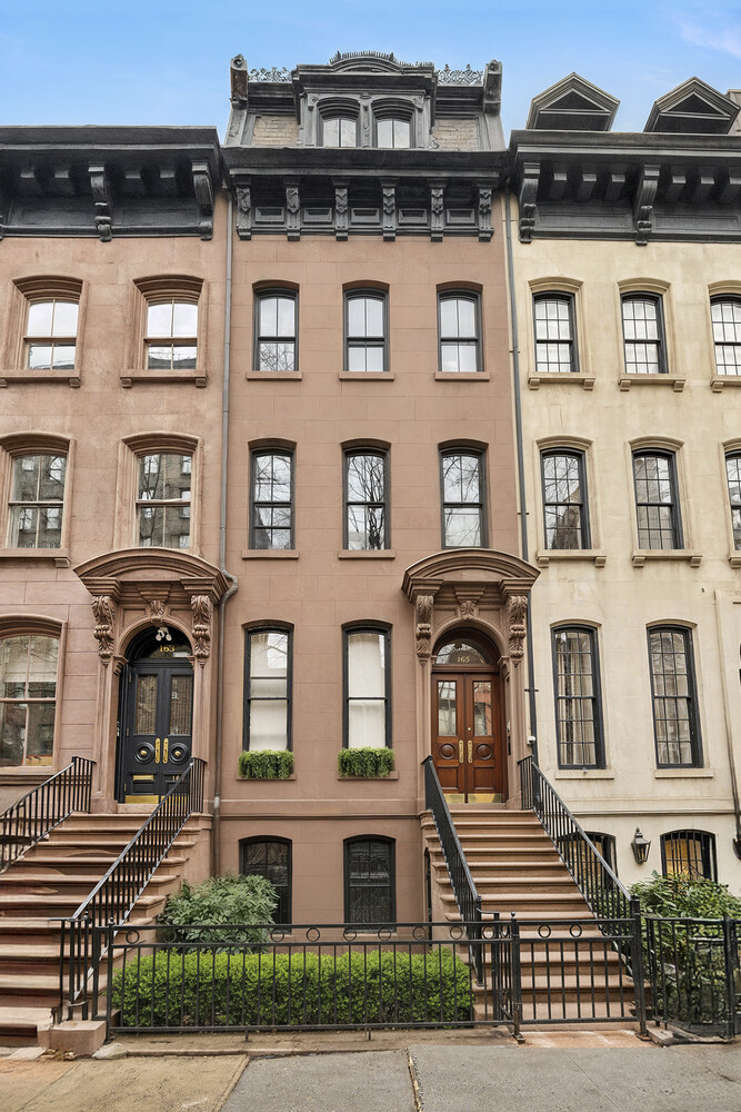 a front view of a residential apartment building with a yard