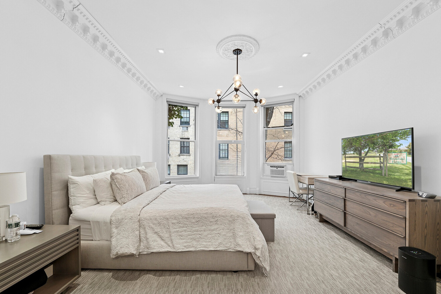 165 East 71st Street Manhattan, NY 10021 - Photo 4 of 12 a spacious bedroom with a bed and a flat screen tv