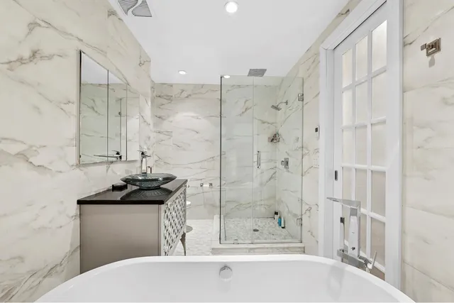 a spacious bedroom with a bed and a flat screen tv