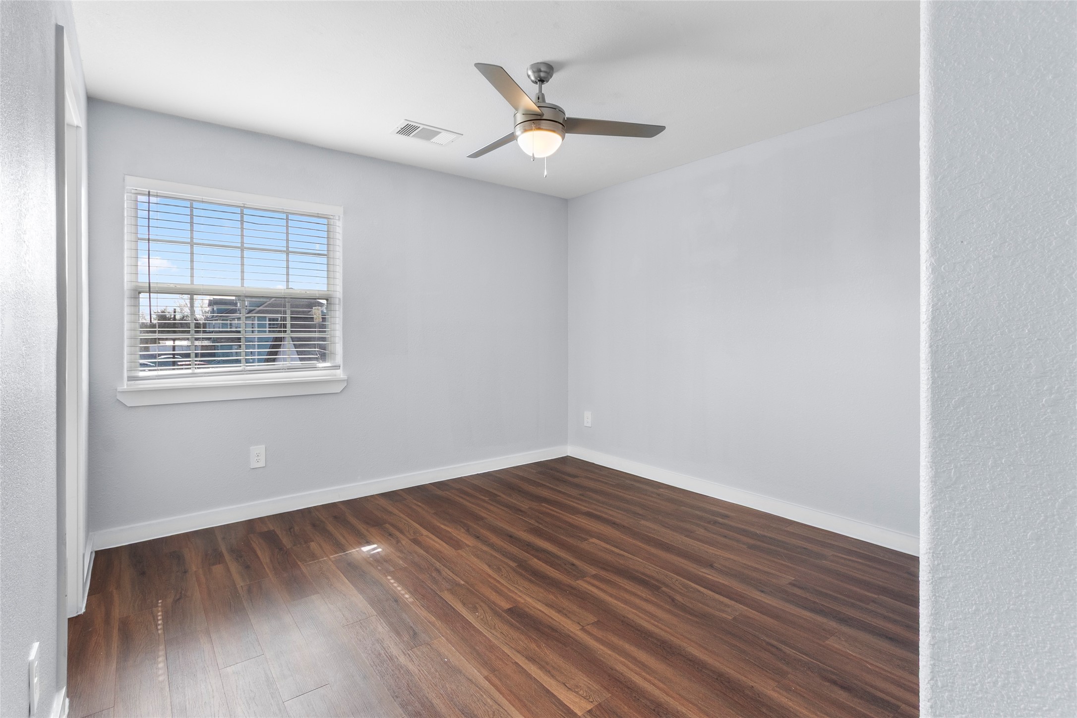 6809 Glass Street, Unit A Houston, TX 77016 - Photo 6 of 17 wooden floor in an empty room with a window