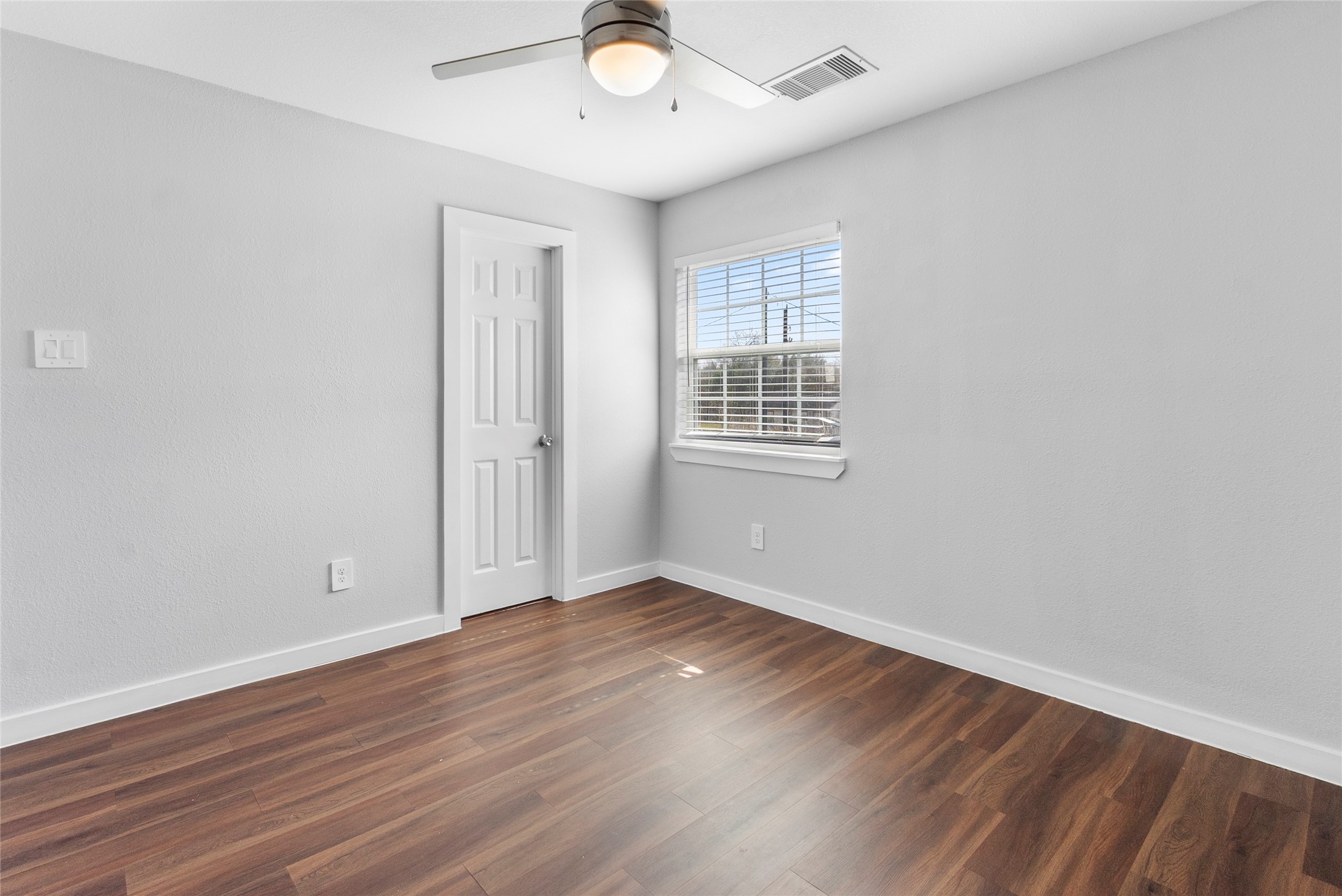 6809 Glass Street, Unit A Houston, TX 77016 - Photo 7 of 17 wooden floor in an empty room with a window