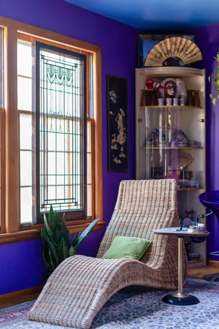 a view of a dining room with furniture a chandelier and window
