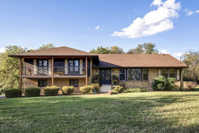 a front view of a house with a yard table and chairs