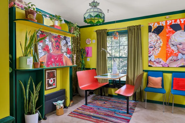 a living room filled with furniture and a large window