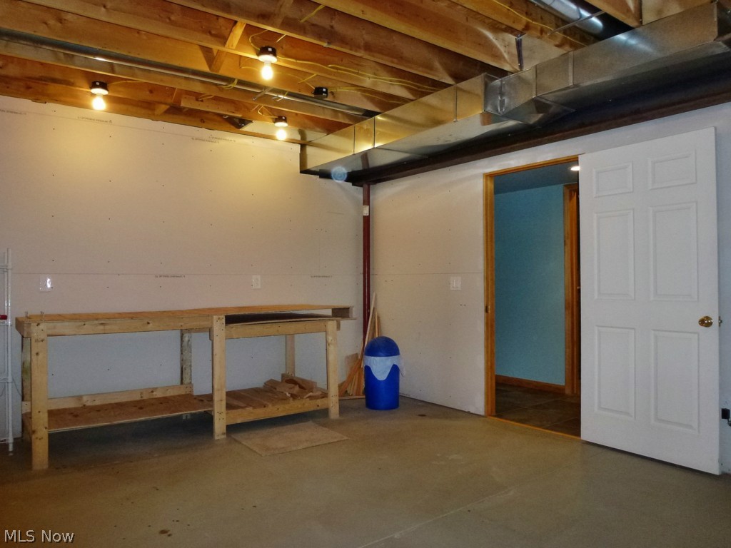 13591 Spring Street Burton, OH 44021 - Photo 24 of 25 18' x 14' Work Shop across from the basement Half Bath and house mechanicals.