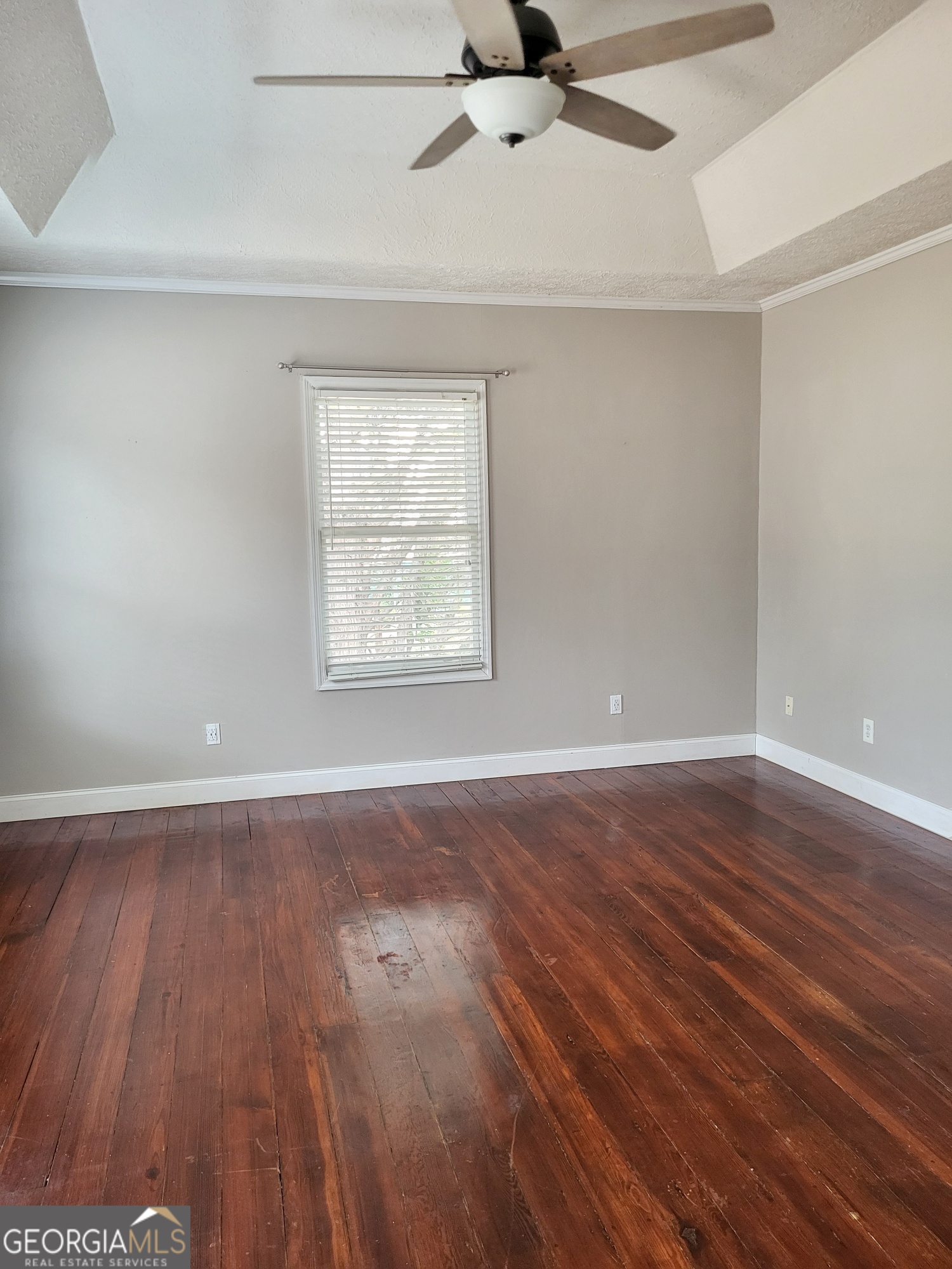 2012 29th Boulevard Valley, AL 36854 - Photo 22 of 29 an empty room with wooden floor fan and windows