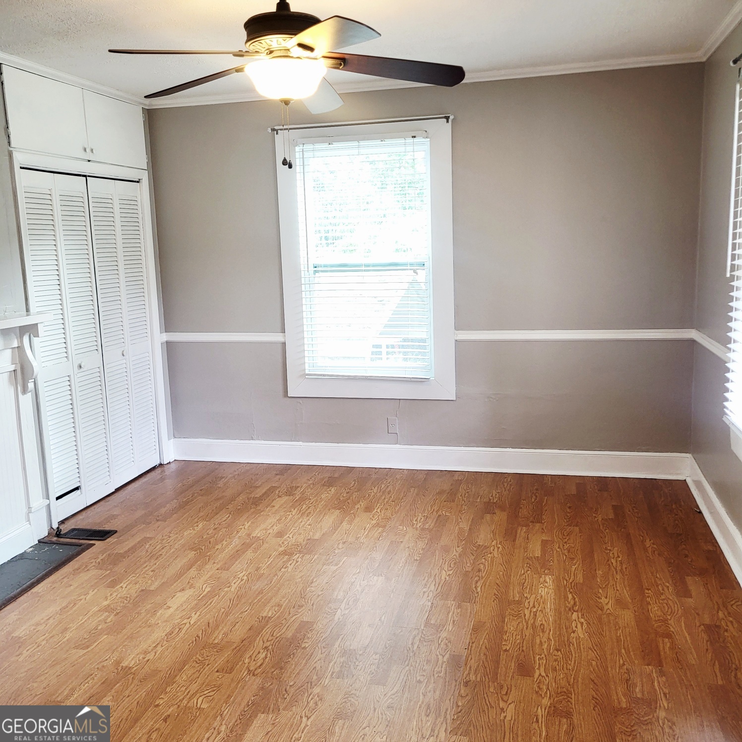 2012 29th Boulevard Valley, AL 36854 - Photo 8 of 29 an empty room with wooden floor fan and window