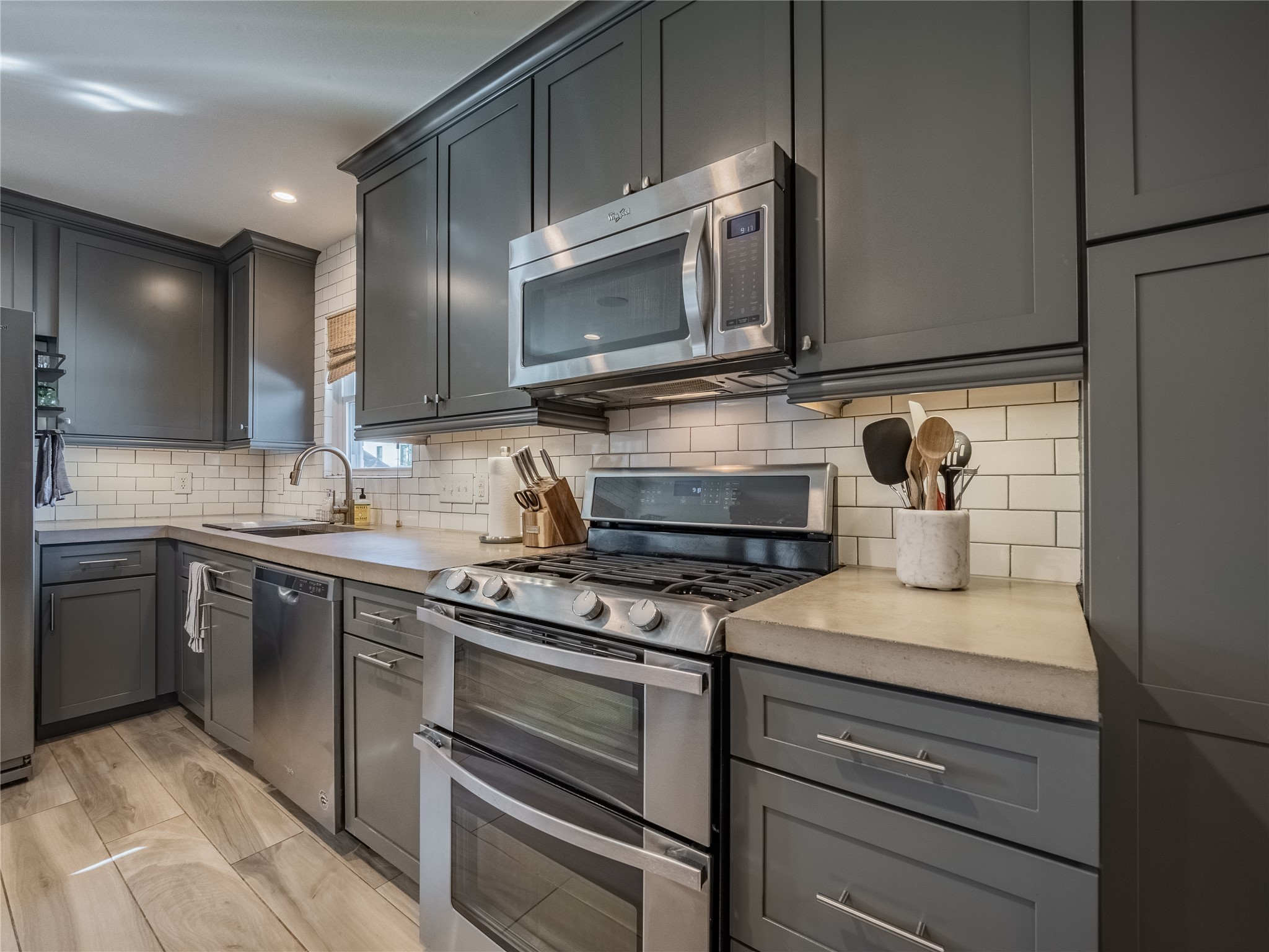 3010 Conway Street Houston, TX 77025 - Photo 11 of 21 a kitchen with stainless steel appliances granite countertop a sink and a stove top oven with granite countertops
