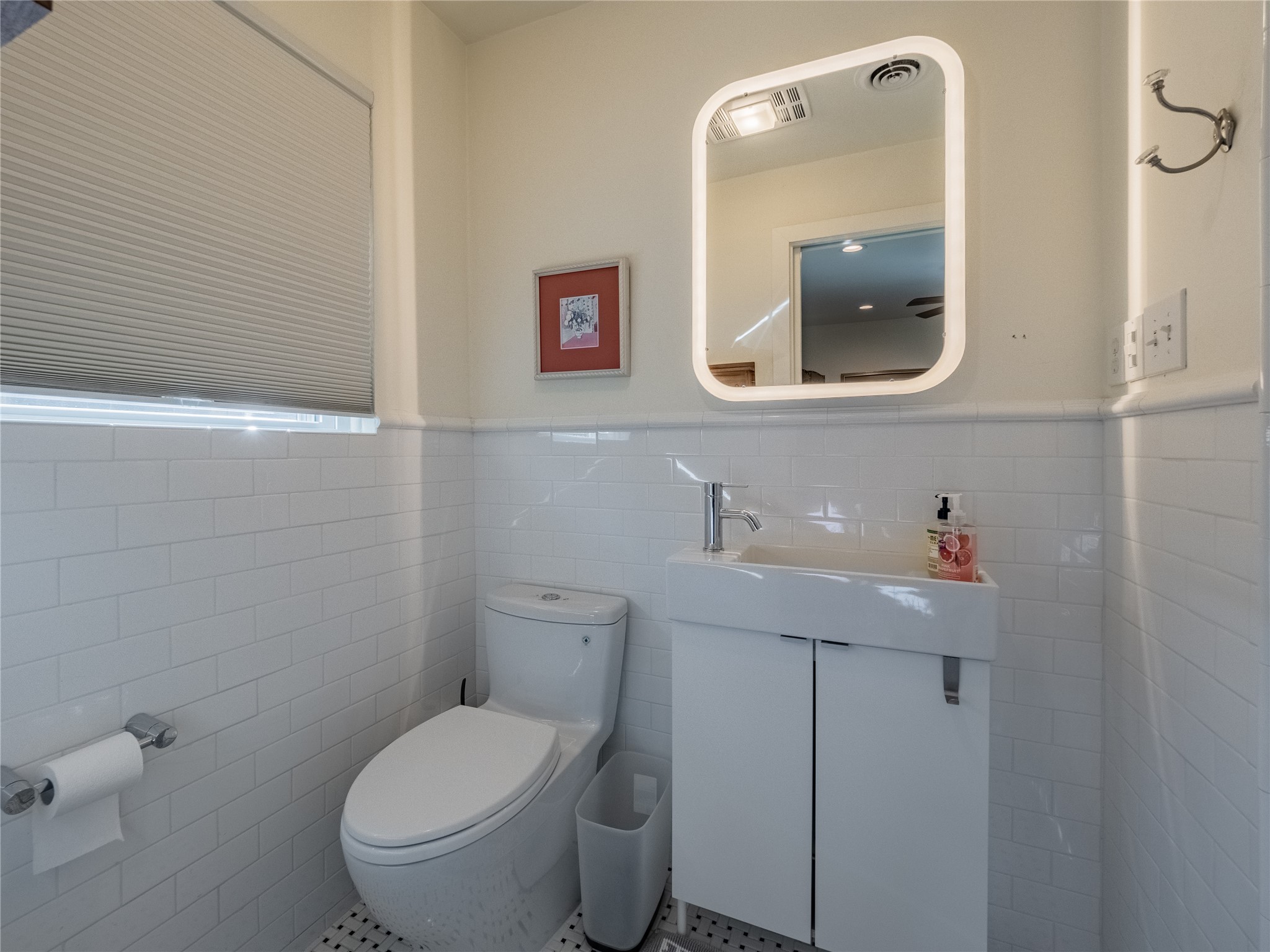3010 Conway Street Houston, TX 77025 - Photo 16 of 21 a bathroom with a toilet sink vanity and mirror