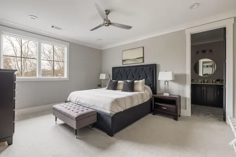 a bedroom with a bed table and window