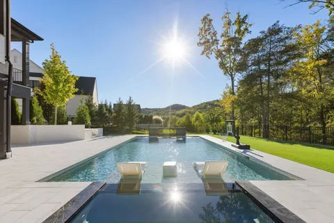 swimming pool view with a seating space