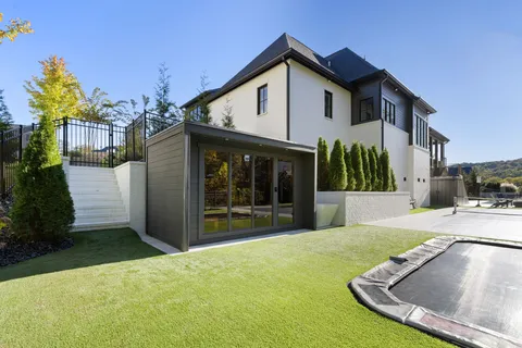 a view of a house with a yard and porch