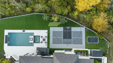 an aerial view of a house with a garden and swimming pool