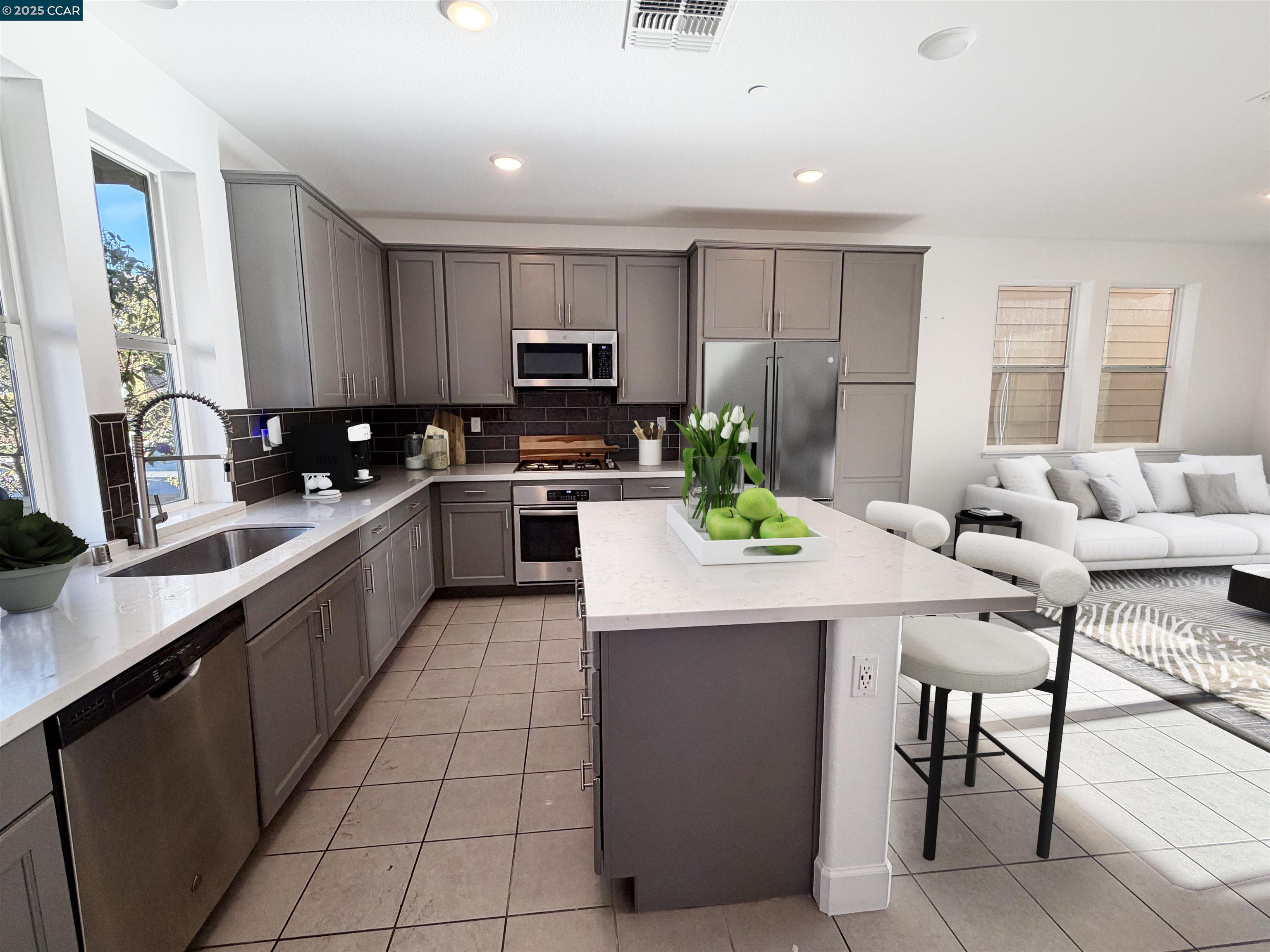 1861 Shasta Lane Hercules, CA 94547 - Photo 13 of 22 a kitchen with stainless steel appliances kitchen island granite countertop a stove a sink a microwave a dining table and chairs