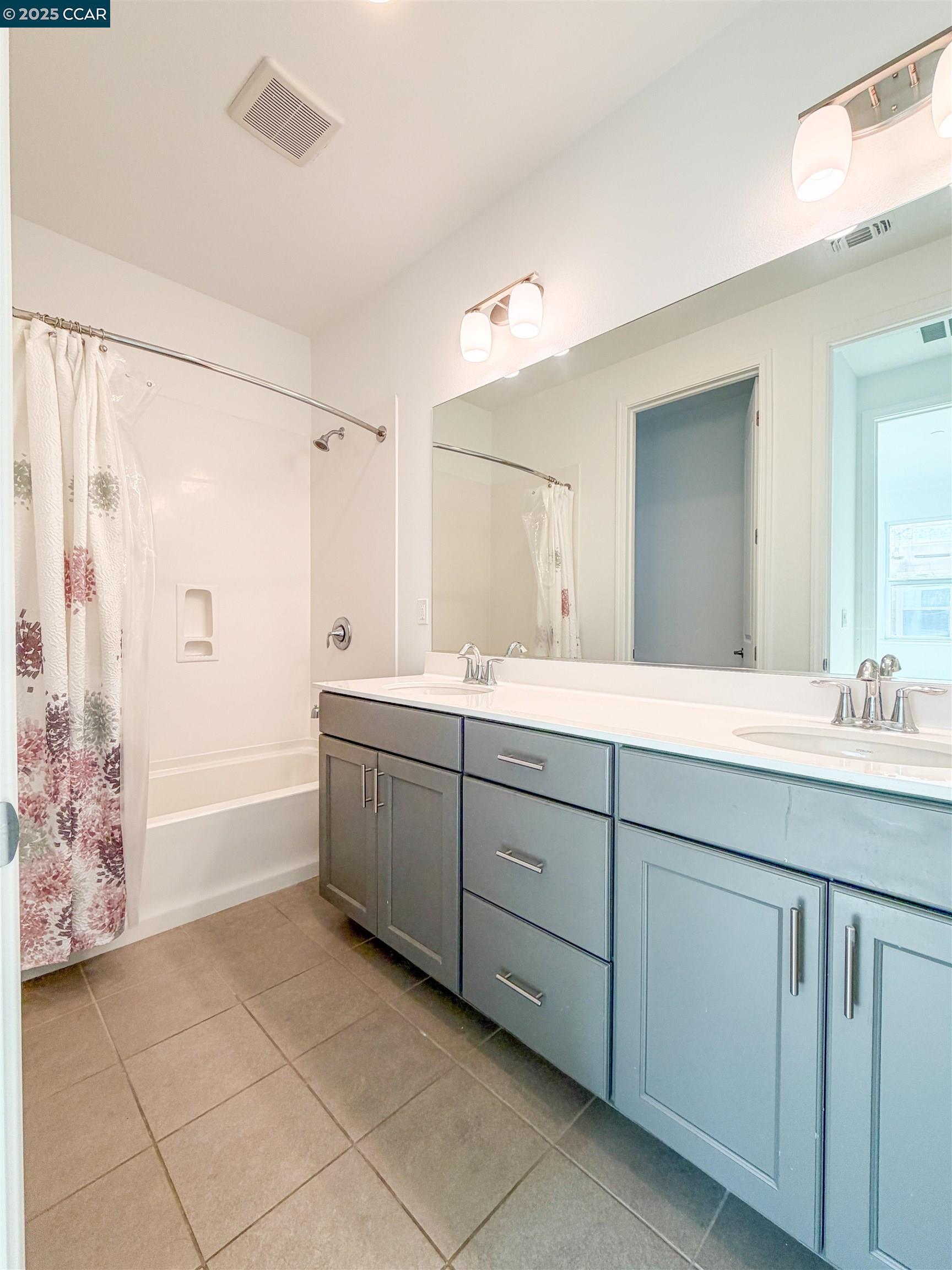 1861 Shasta Lane Hercules, CA 94547 - Photo 16 of 22 a spacious bathroom with a double vanity sink a mirror and a bathtub