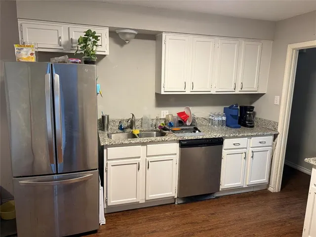 a kitchen with stainless steel appliances granite countertop a refrigerator sink and cabinets
