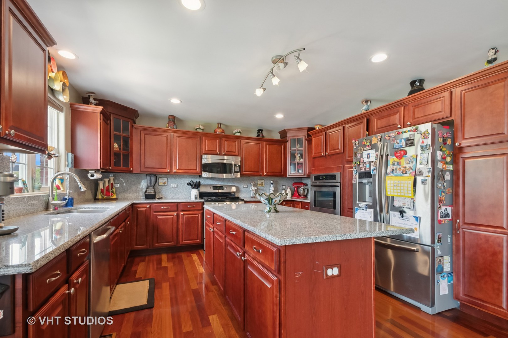 259 Fir Street Beecher, IL 60401 - Photo 11 of 38 a kitchen with stainless steel appliances granite countertop a sink stove and refrigerator
