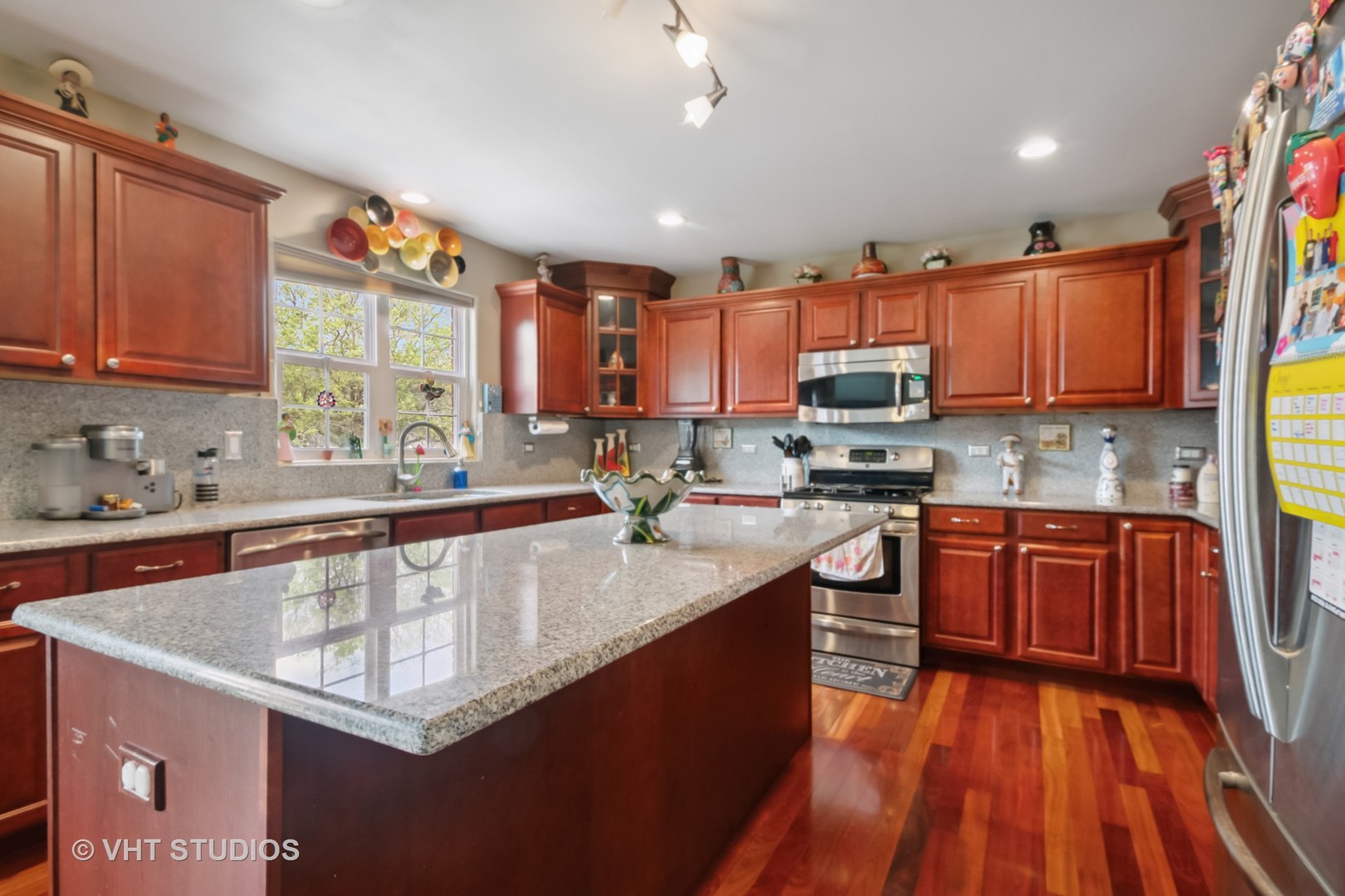 259 Fir Street Beecher, IL 60401 - Photo 12 of 38 a kitchen with stainless steel appliances granite countertop a sink stove and cabinets