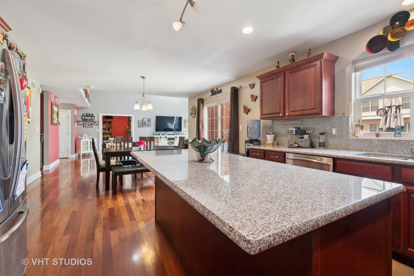 259 Fir Street Beecher, IL 60401 - Photo 13 of 38 a kitchen with stainless steel appliances granite countertop a stove top oven a sink a dining table and chairs with wooden floor