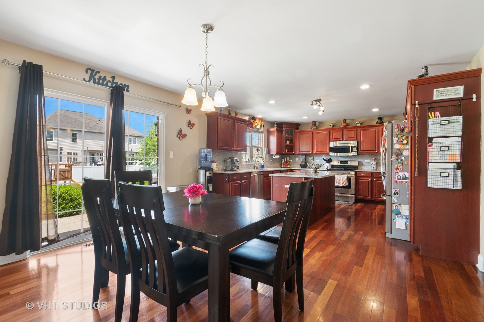 259 Fir Street Beecher, IL 60401 - Photo 10 of 38 a view of a dining room and livingroom with furniture wooden floor a chandelier