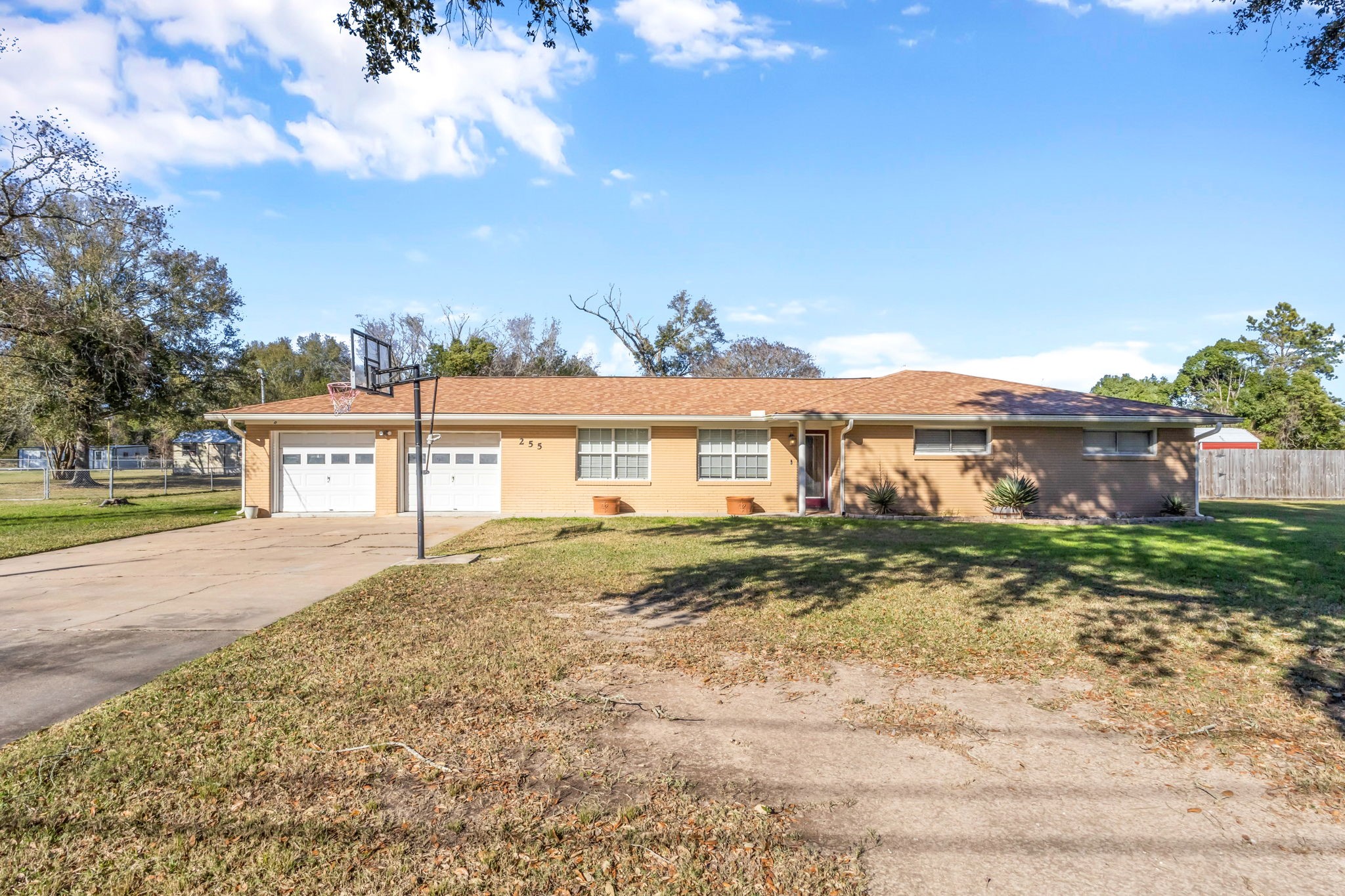255 Gilmer Street Bridge City, TX 77611 - Photo 1 of 37 a view of a big house with a big yard plants and large tree