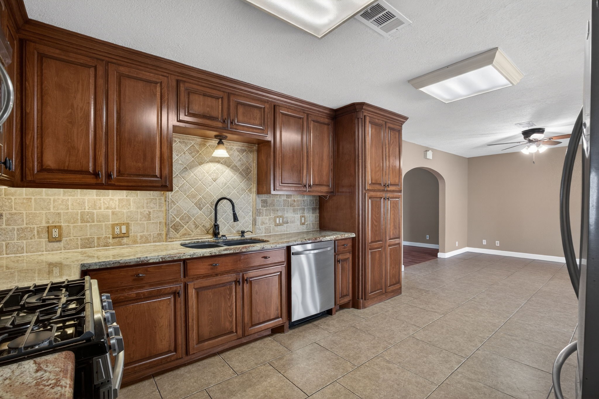 255 Gilmer Street Bridge City, TX 77611 - Photo 13 of 37 a kitchen with stainless steel appliances granite countertop a sink stove and refrigerator