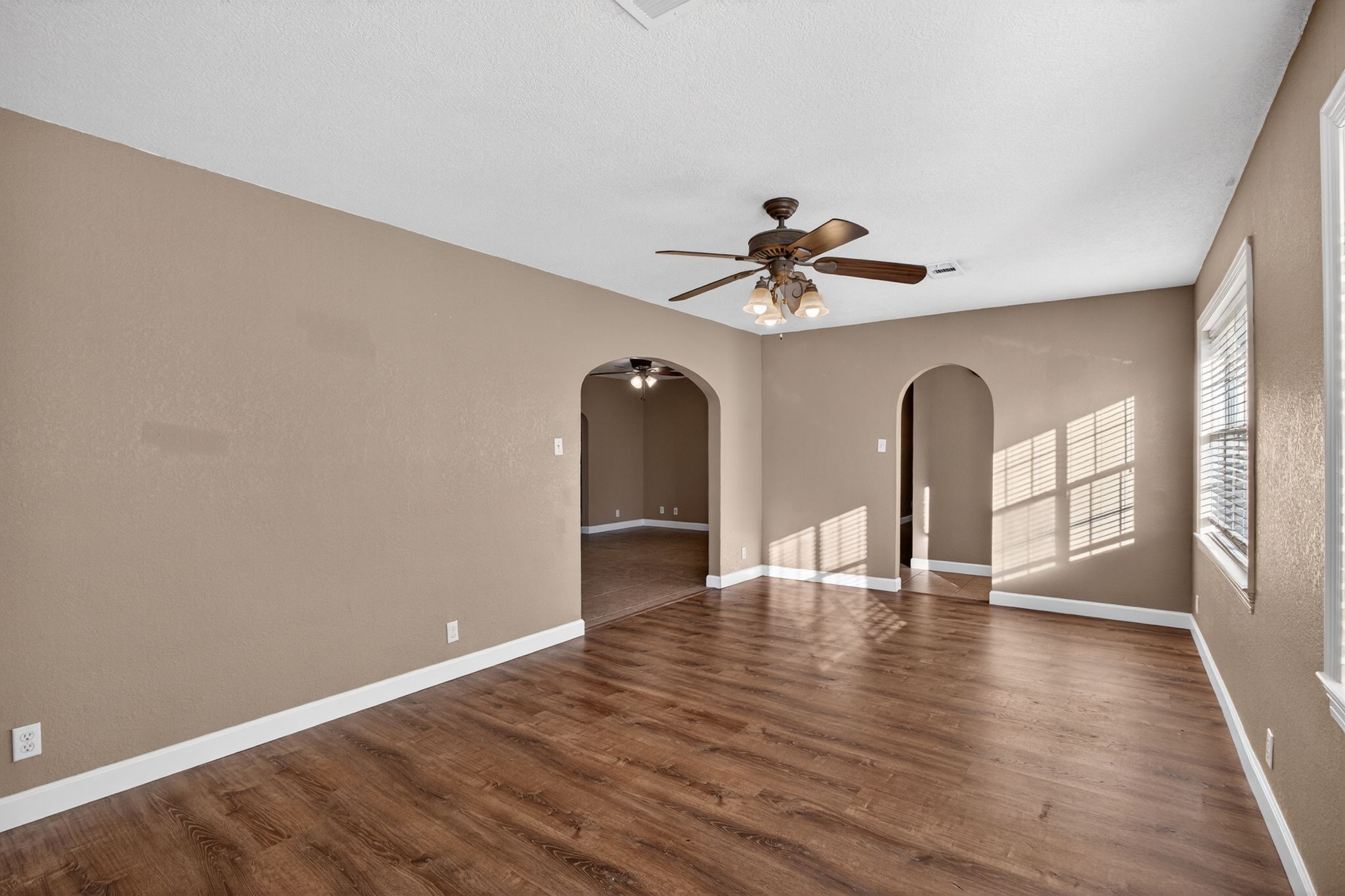 255 Gilmer Street Bridge City, TX 77611 - Photo 15 of 37 a view of an empty room with window and wooden floor
