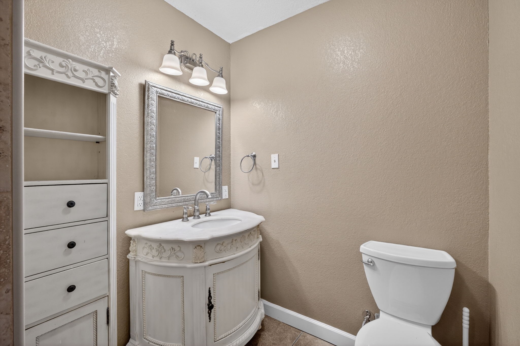 255 Gilmer Street Bridge City, TX 77611 - Photo 24 of 37 a bathroom with a toilet sink and mirror
