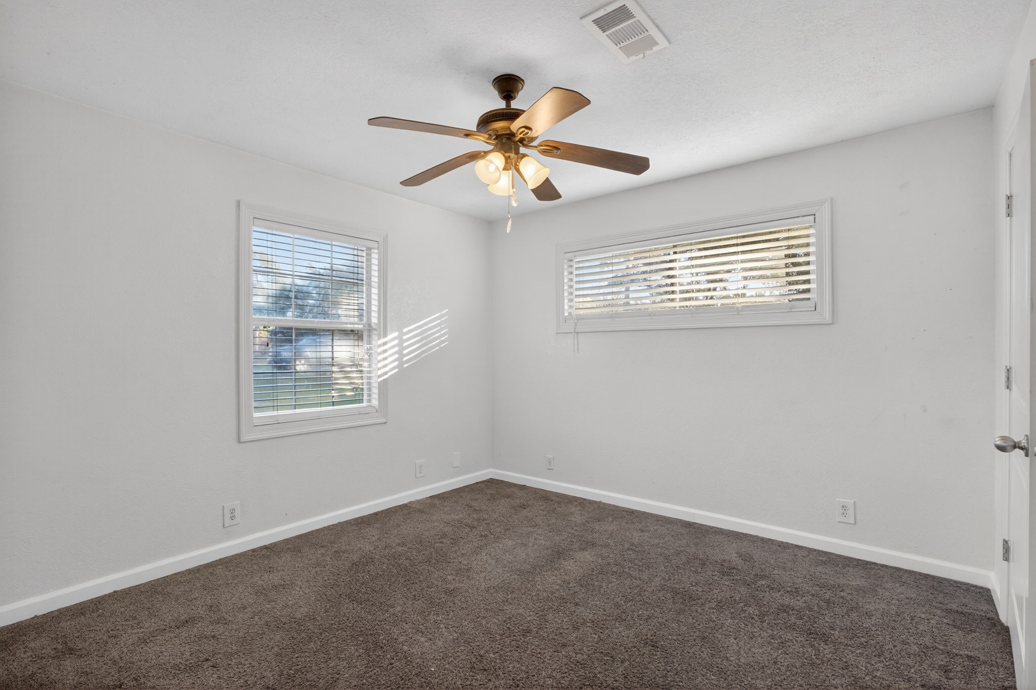 255 Gilmer Street Bridge City, TX 77611 - Photo 29 of 37 an empty room with windows and fan