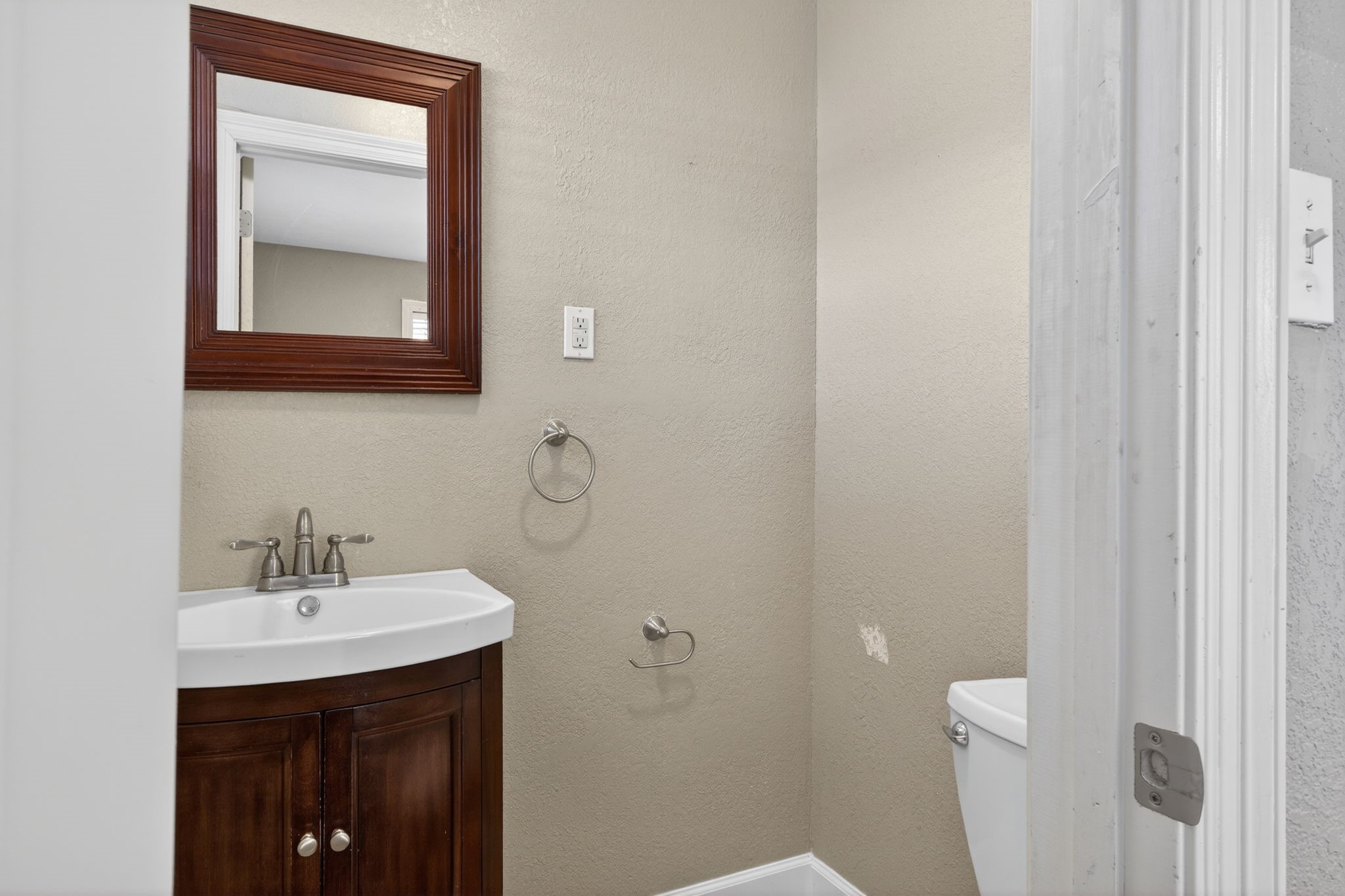 255 Gilmer Street Bridge City, TX 77611 - Photo 31 of 37 a bathroom with a sink and a mirror