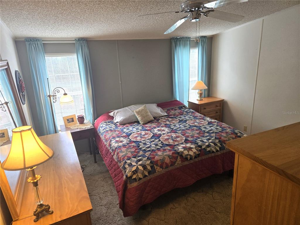 2121 Southeast 170th Avenue Road Silver Springs, FL 34488 - Photo 12 of 23 a bedroom with a bed and wooden floor