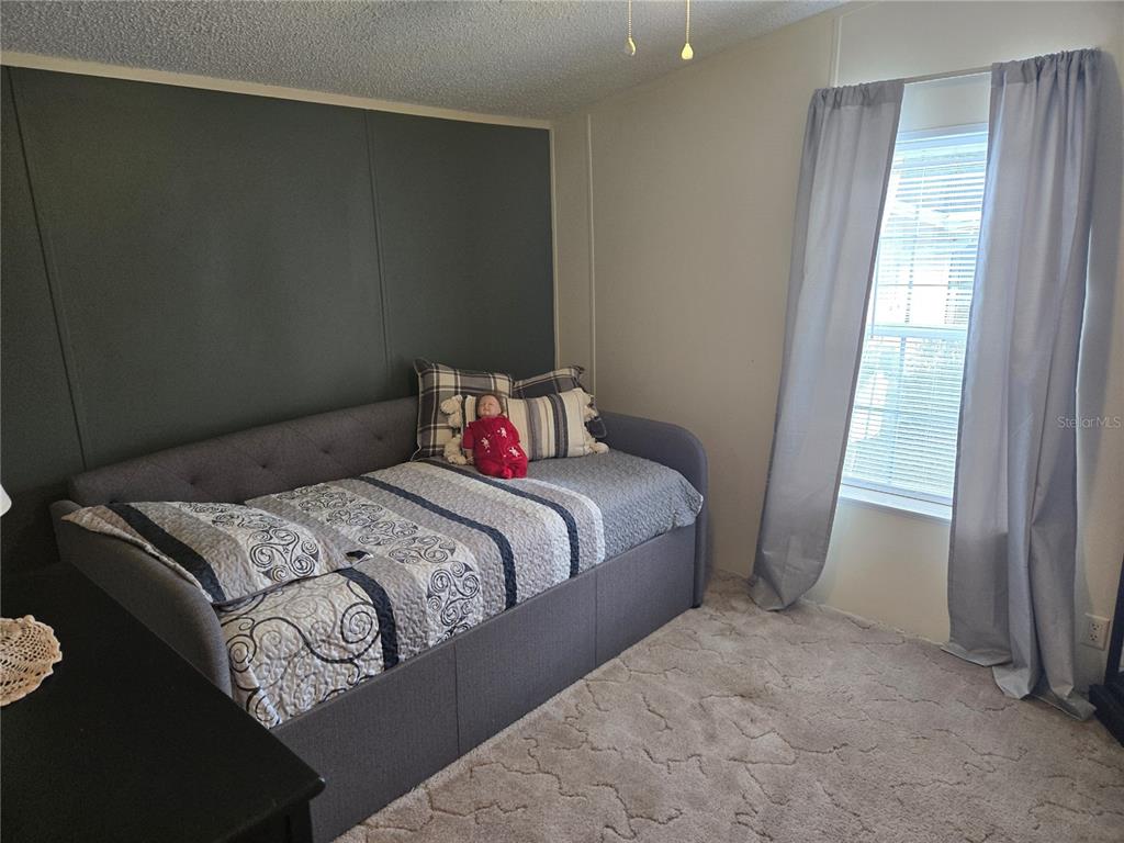 2121 Southeast 170th Avenue Road Silver Springs, FL 34488 - Photo 14 of 23 a bedroom with a bed and a window
