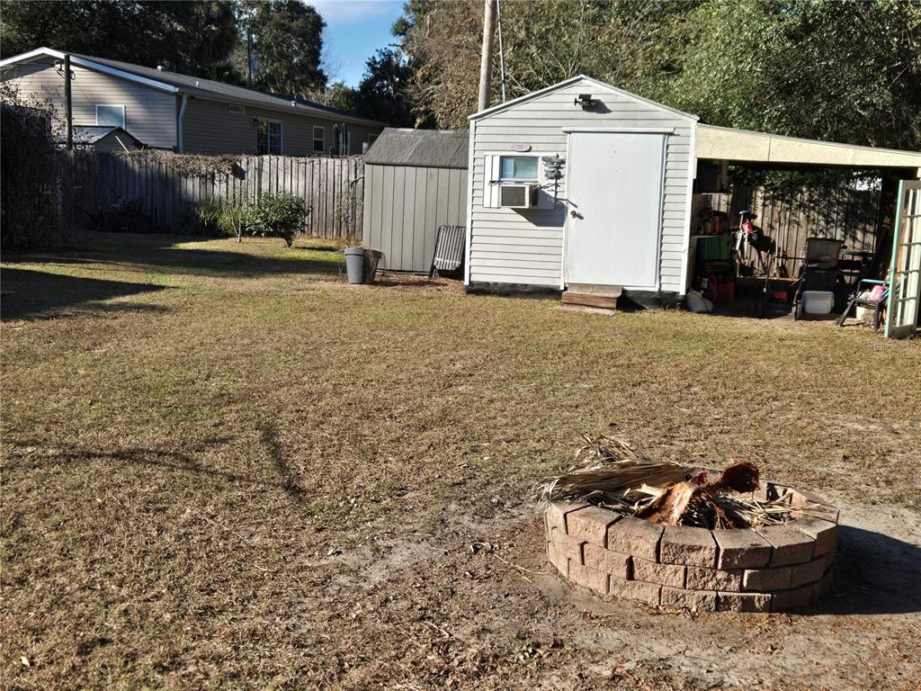 2121 Southeast 170th Avenue Road Silver Springs, FL 34488 - Photo 20 of 23 a front view of a house with garden