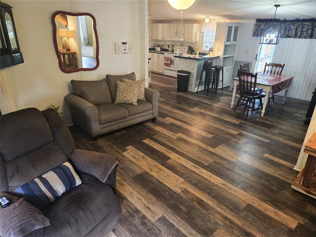 2121 Southeast 170th Avenue Road Silver Springs, FL 34488 - Photo 4 of 23 a living room with lots of furniture and kitchen view