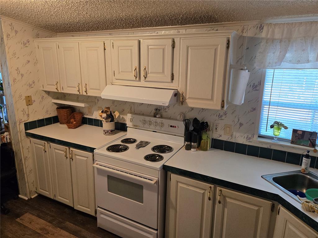 2121 Southeast 170th Avenue Road Silver Springs, FL 34488 - Photo 6 of 23 a kitchen with stainless steel appliances granite countertop a sink stove and cabinets