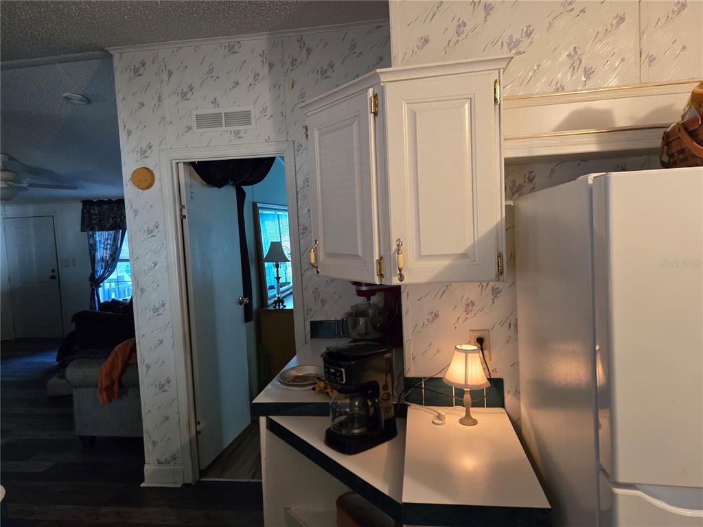 2121 Southeast 170th Avenue Road Silver Springs, FL 34488 - Photo 8 of 23 a kitchen with refrigerator and window
