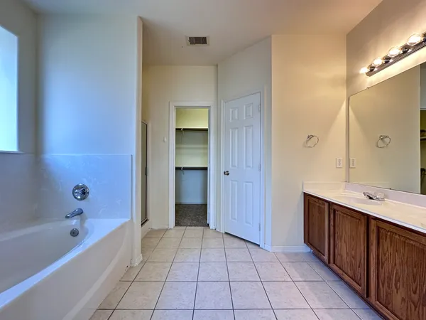 a bathroom with a bathtub and a sink