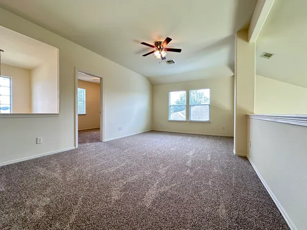 a view of a livingroom with a ceiling fan and window
