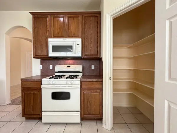 a kitchen with a stove and a microwave