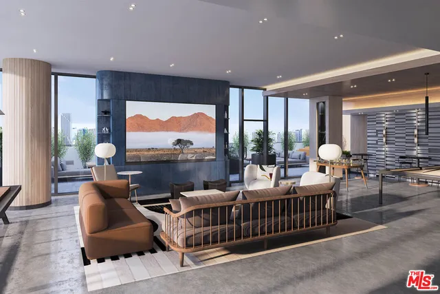 a living room with furniture fireplace and a large window