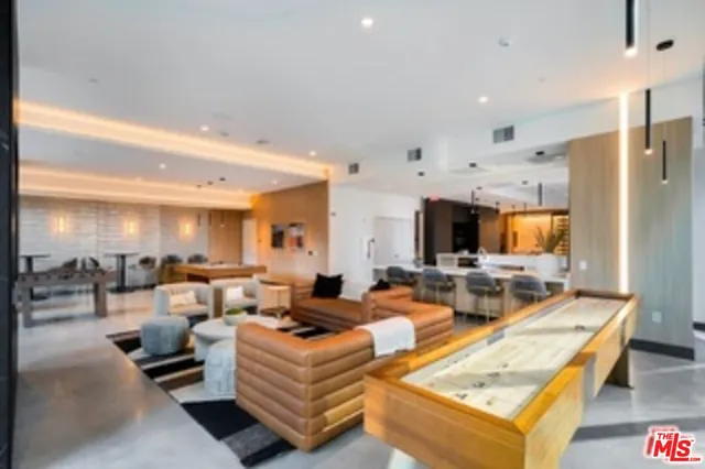 a living room with fireplace furniture and a large window