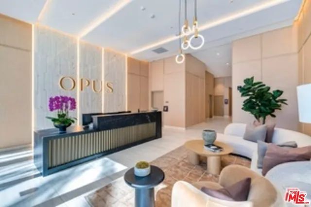 a living room with furniture and flowers